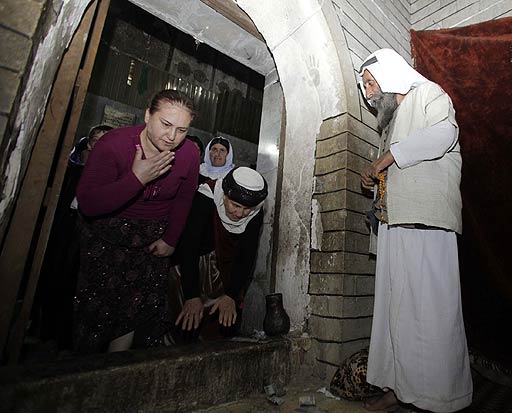 Yazidis pay their respects within the Lalish temple.
